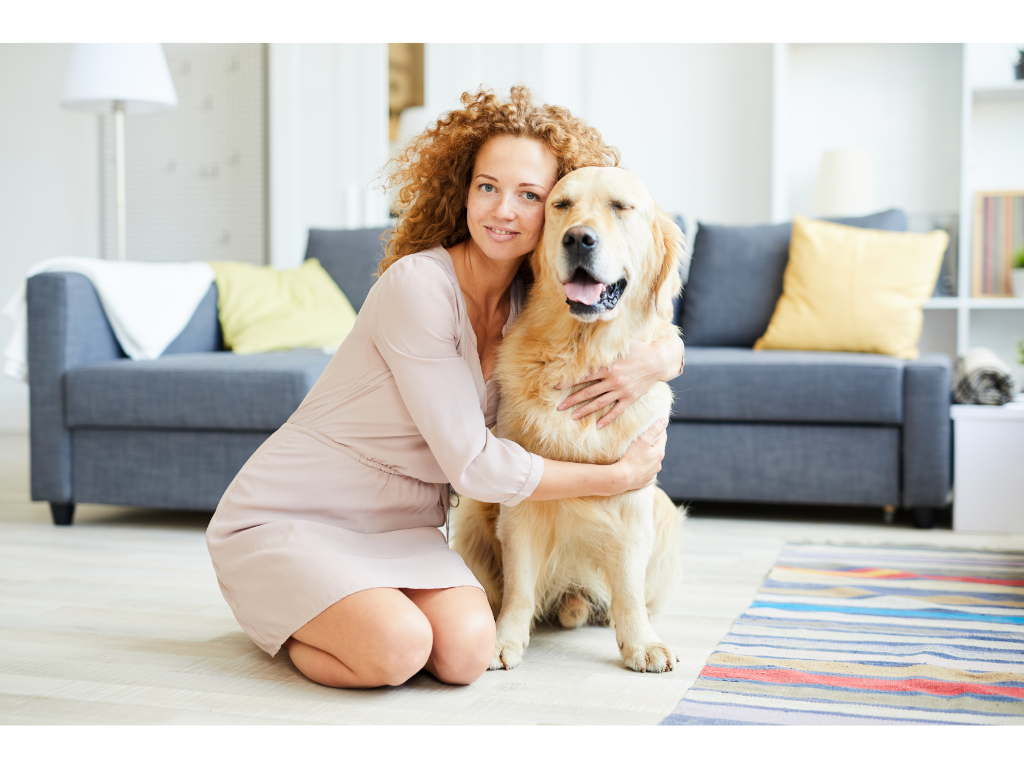 A woman hugging her pet Labrador Retriever