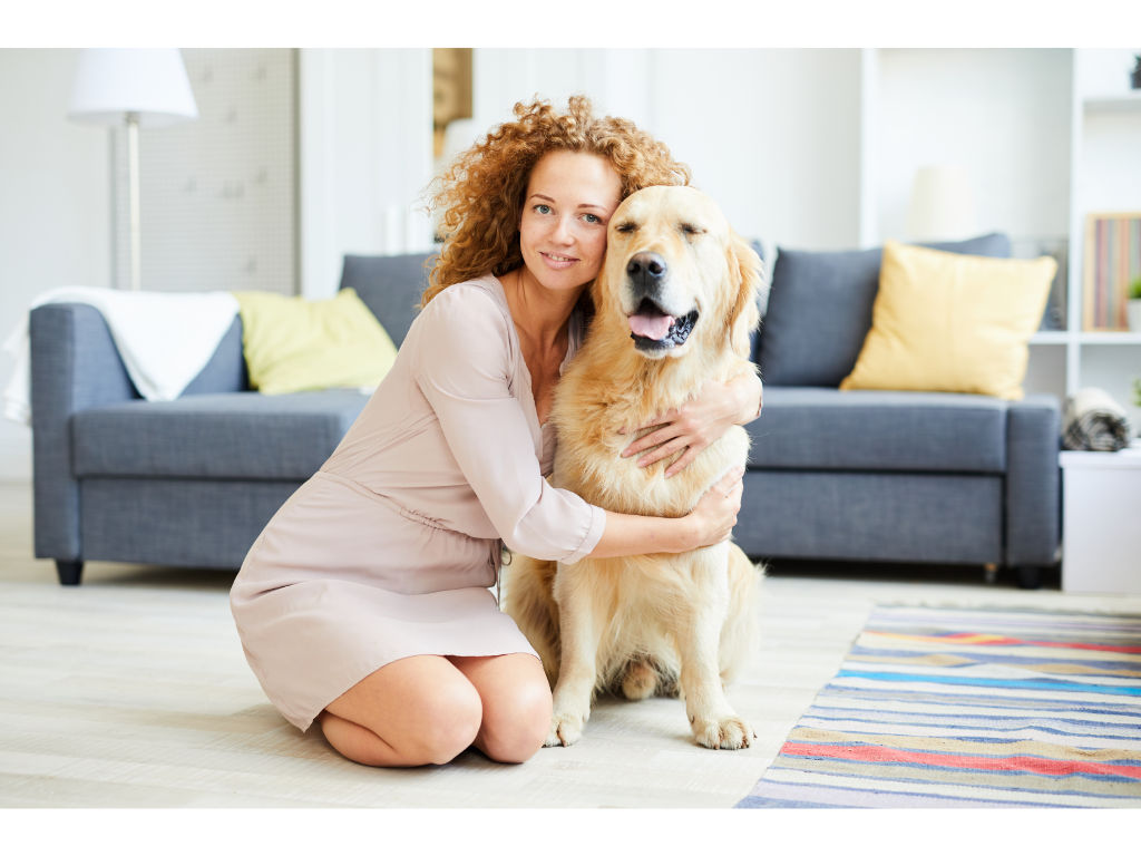 A woman hugging her pet Labrador Retriever 