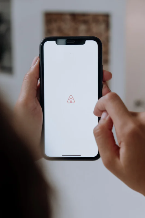 A property investor opening the Airbnb app