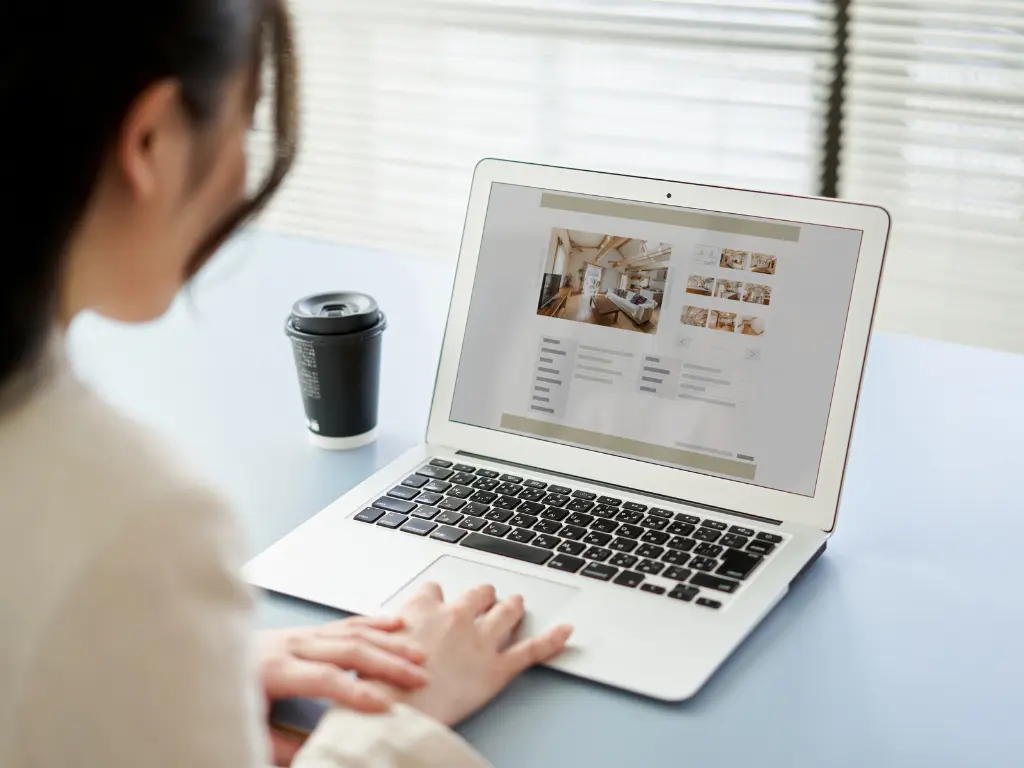 A young woman viewing a rental property online.