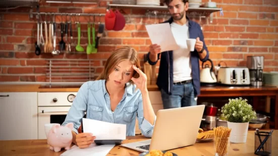 A young couple looking at their property management fees breakdown