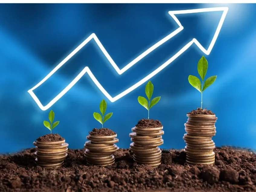 Piles of coins gradually getting bigger with a trend arrow representing investment growth